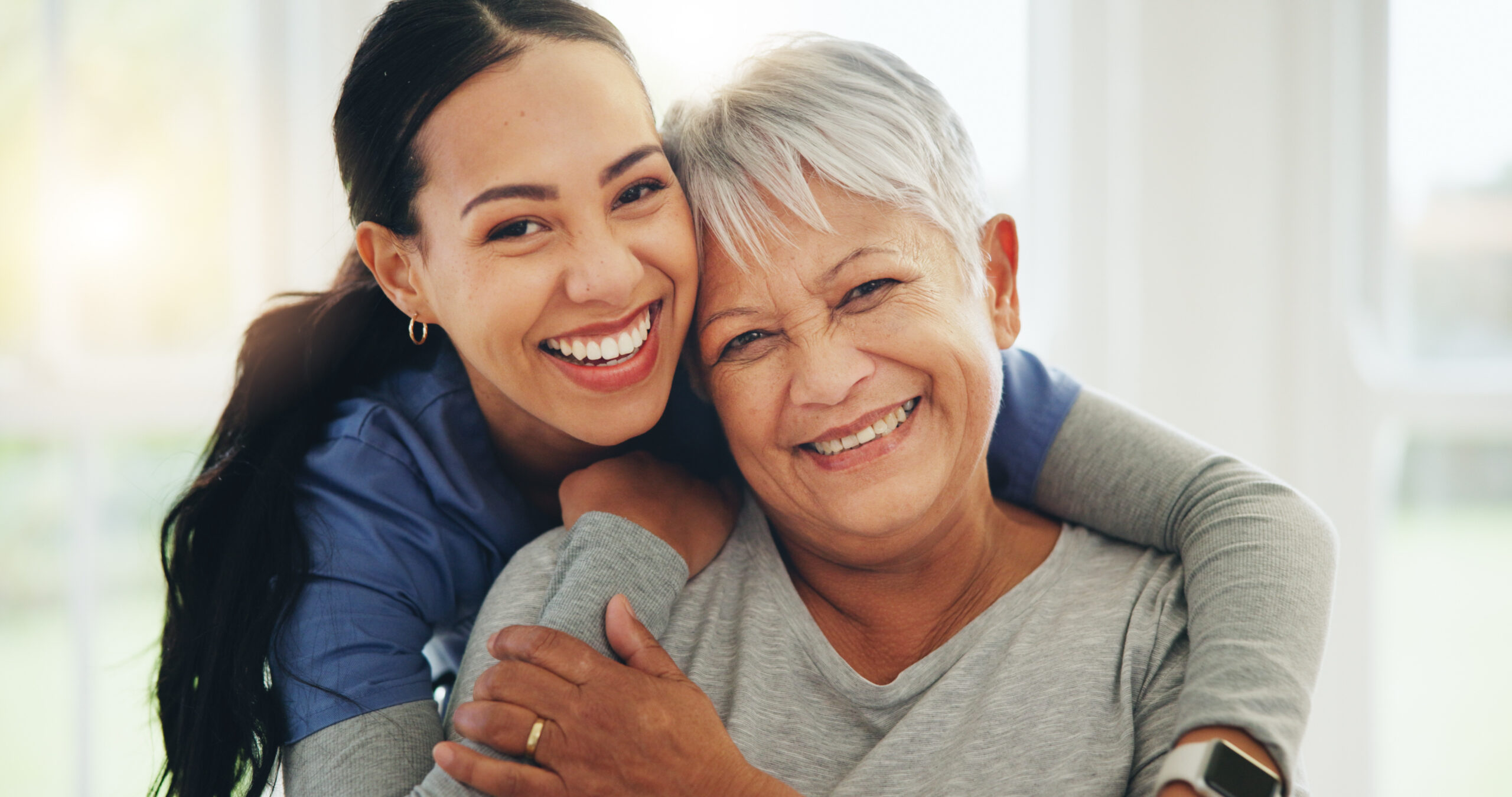 Happy senior woman and female nurse smile and embrace Happy senior woman and female nurse smile and embrace.